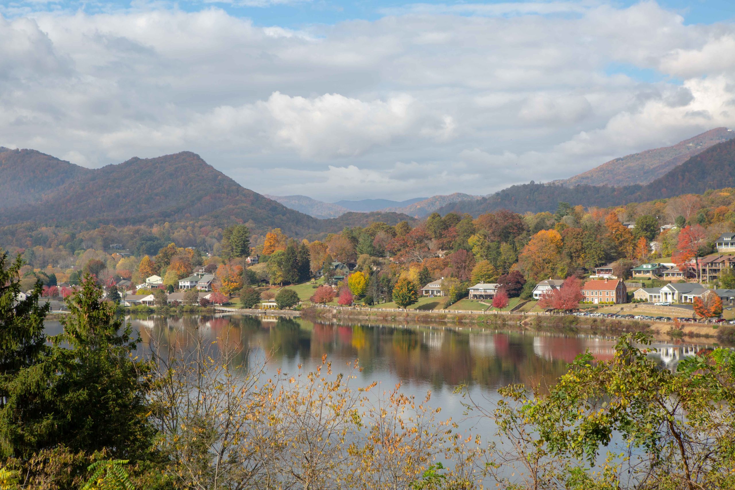 Lake Junaluska aerial photo showing fall foliage colors and the walking bridge