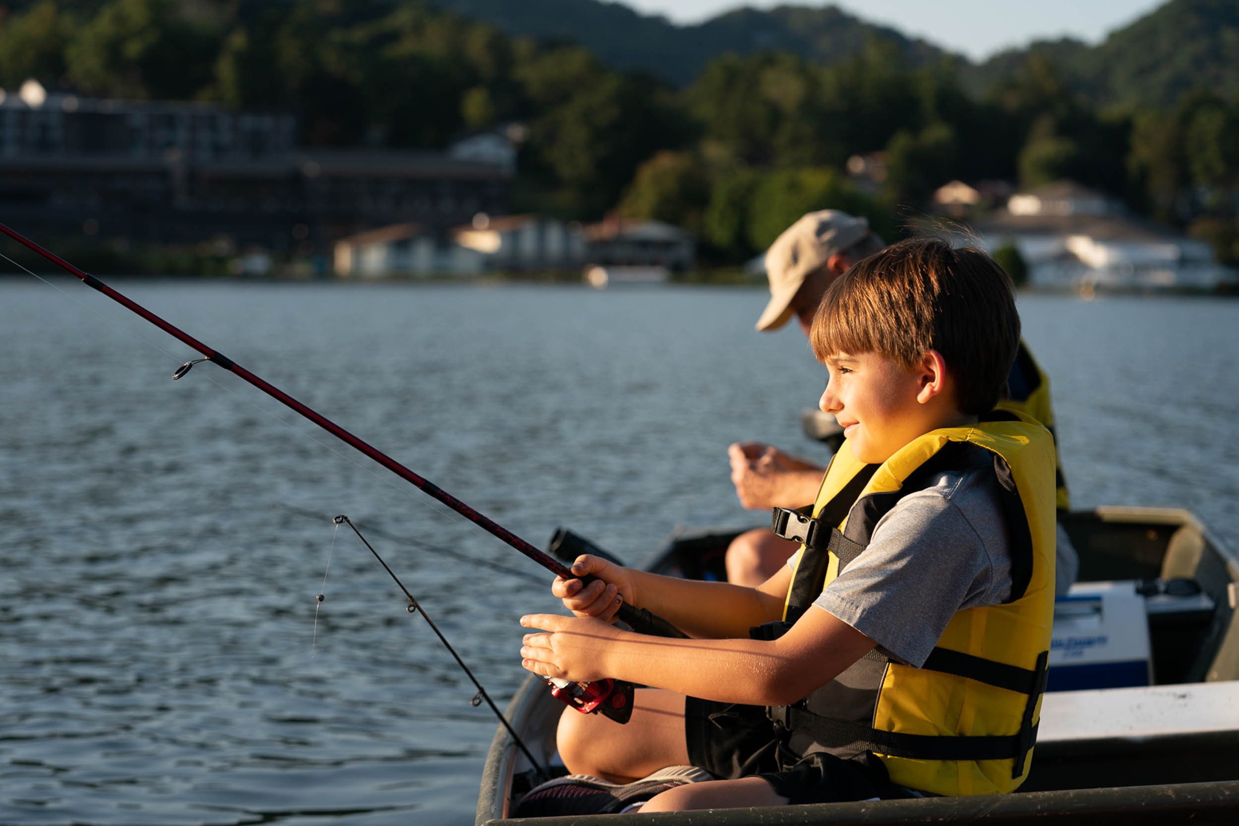 Grandson and grandfather fishing together on Lake Junaluska