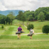 Father and son walking down the fairway of a Lake Junaluska Golf Course hole.