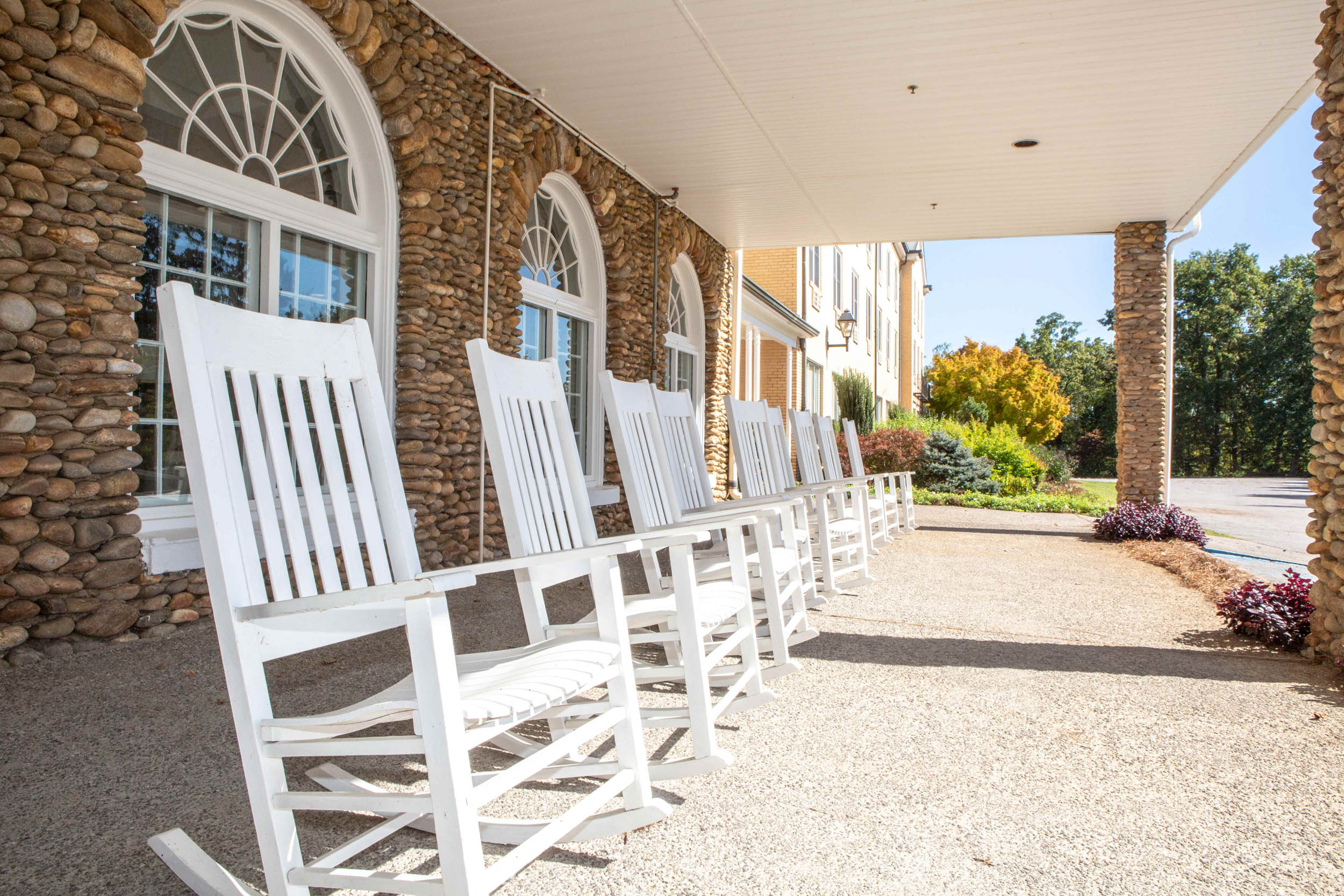 Detail of the front porch of The Lambuth Inn with a row of rocking chairs for guests