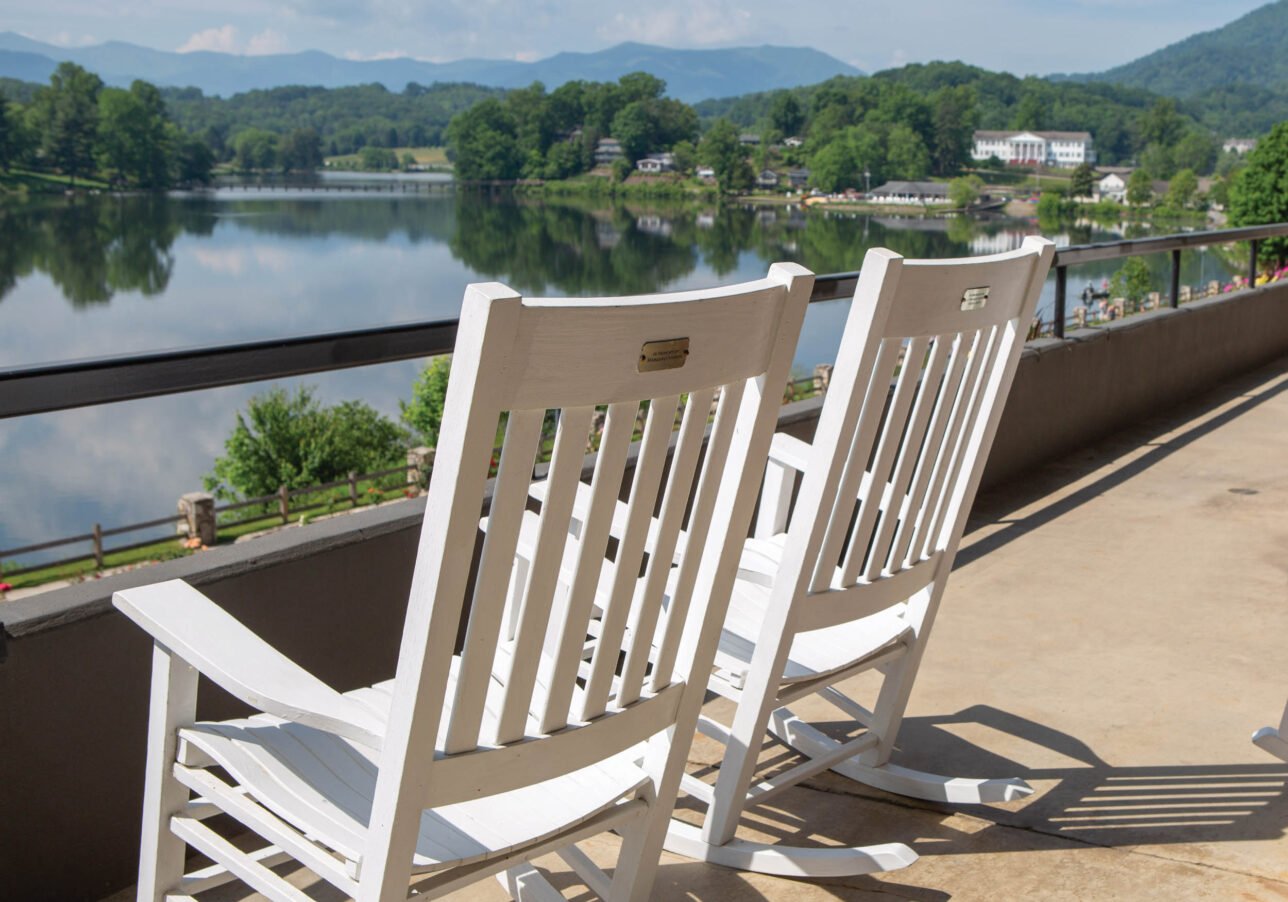 Two rocking chairs sitting on the porch of The Terrace Hotel at Lake Junaluska