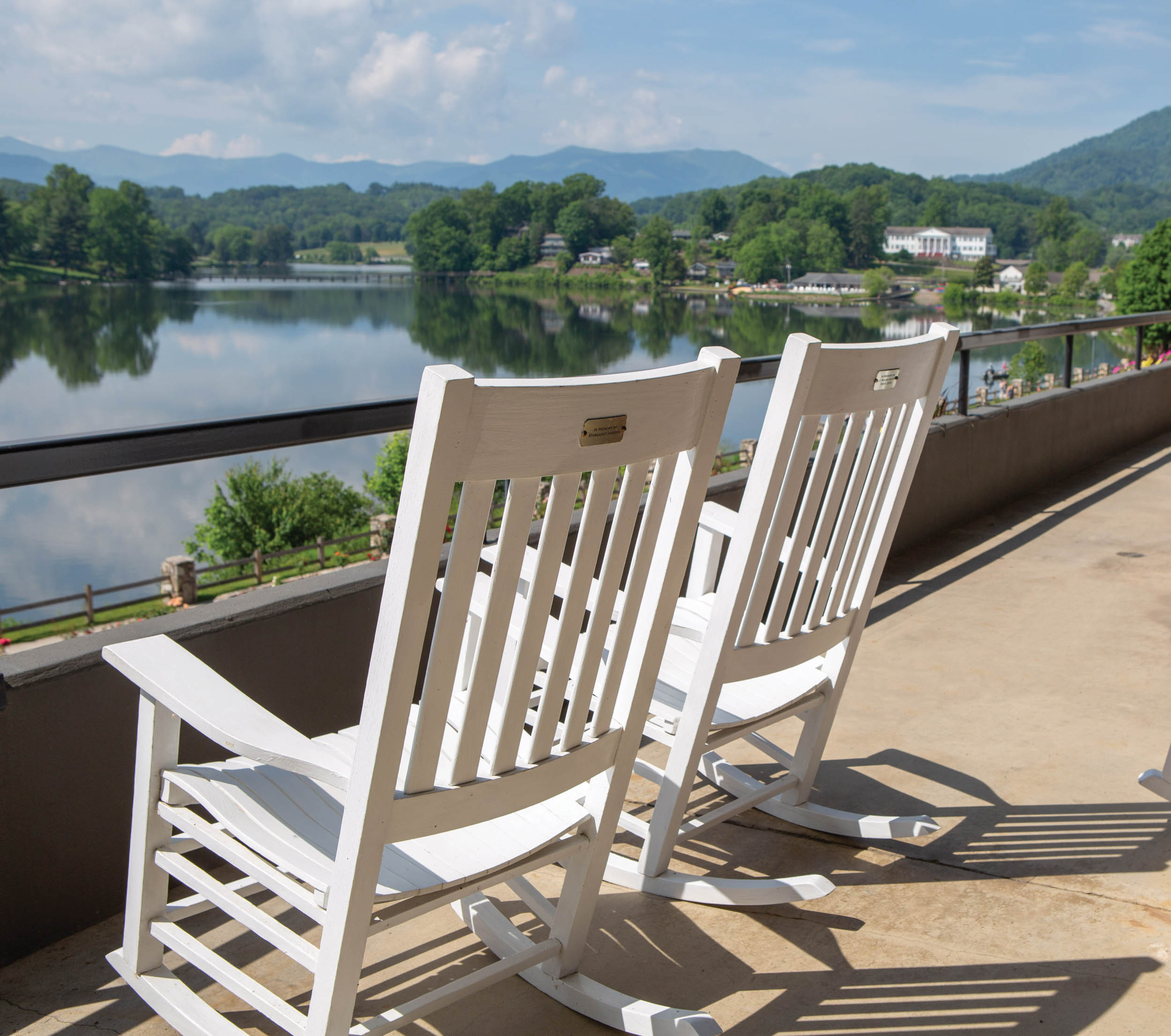 Two rocking chairs sitting on the porch of The Terrace Hotel at Lake Junaluska