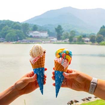 Two ice cream cones with Lake Junaluska in the background