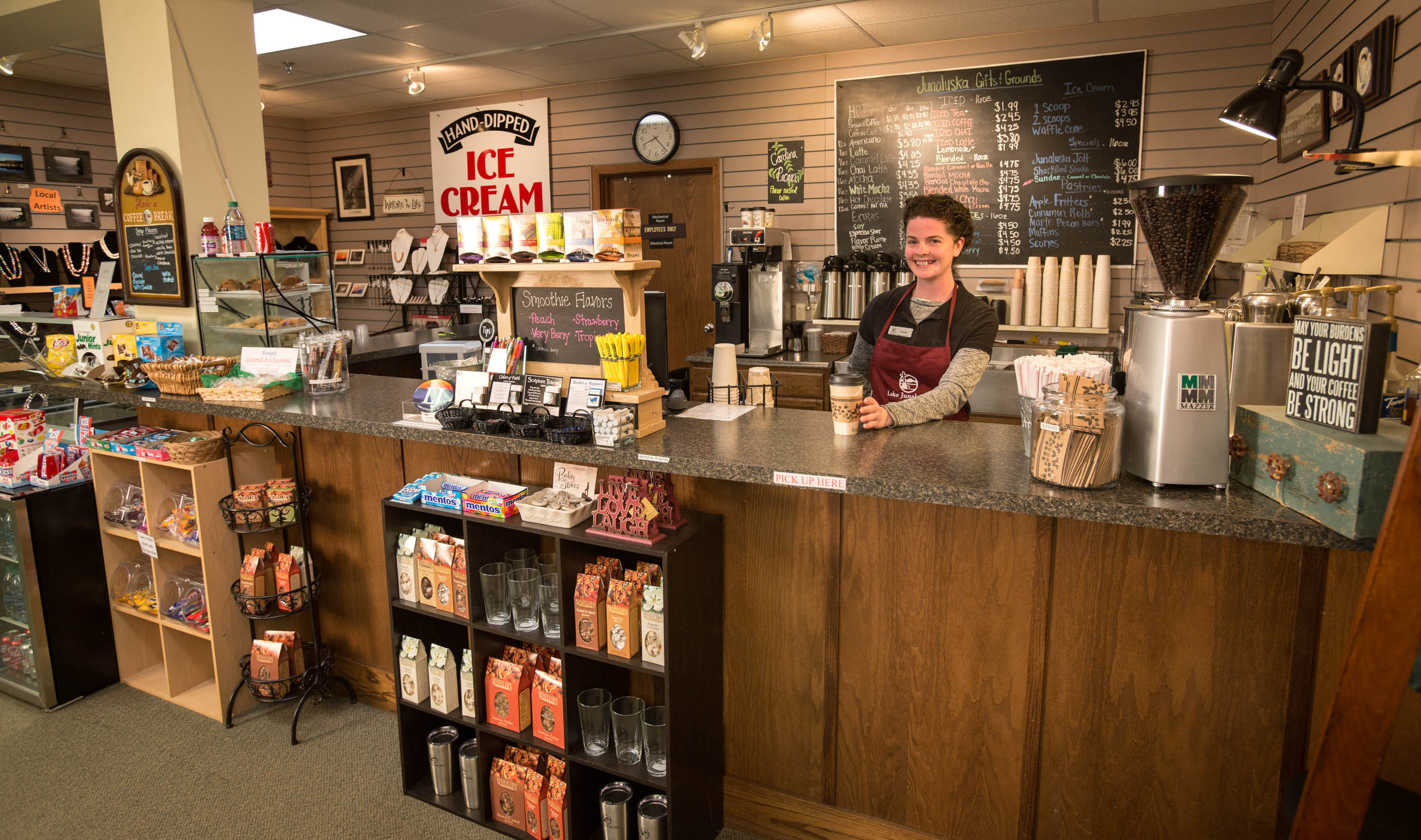 Barista smiling behind the Junaluska Gifts and Grounds coffee counter