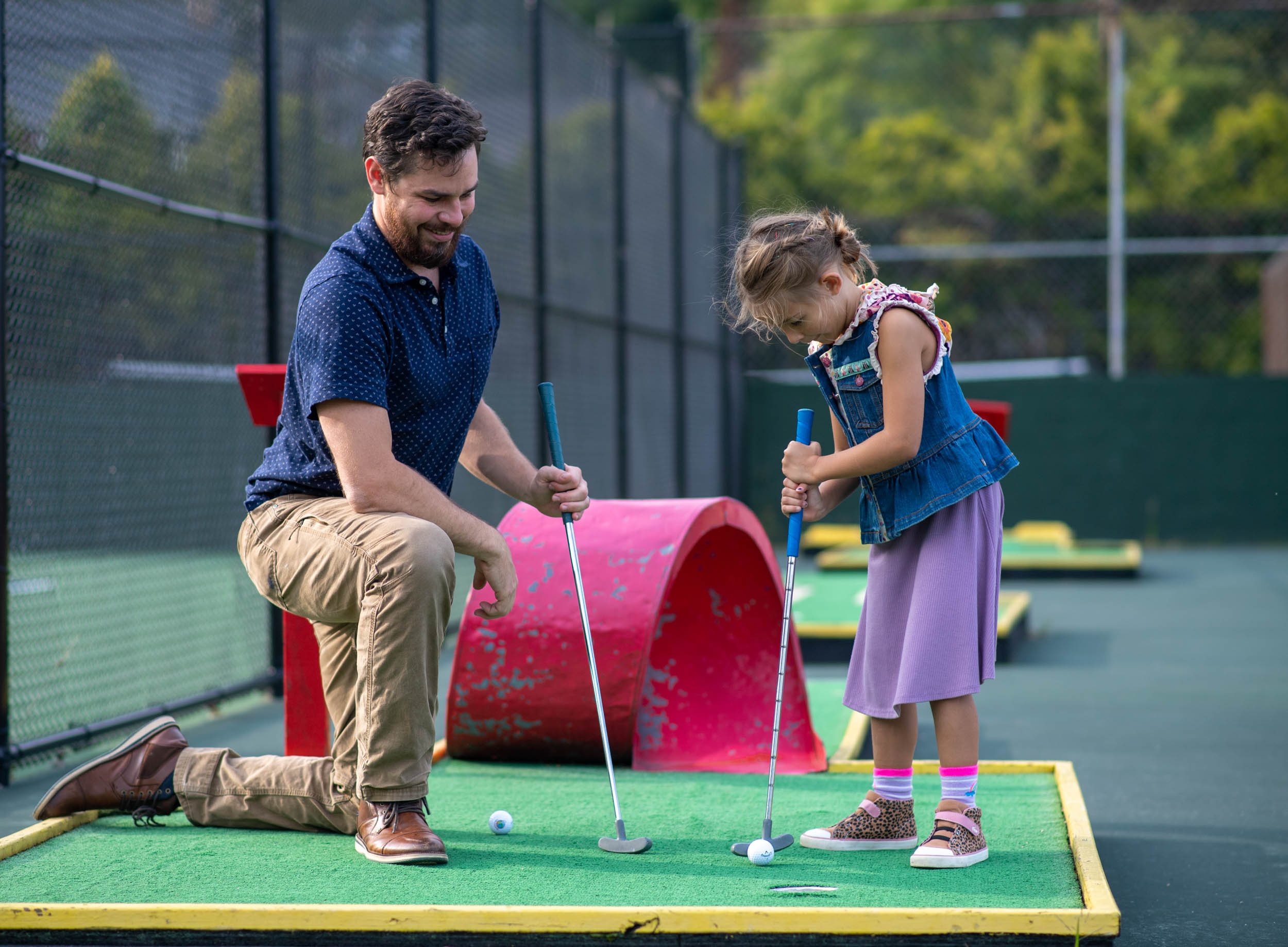 Dad and young daughter playing mini golf at Lake Junaluska