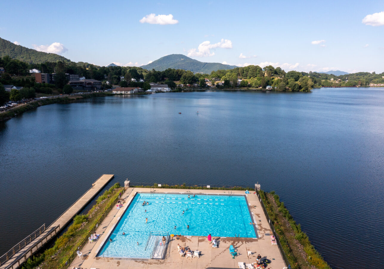Aerial view of lakeside pool in summer