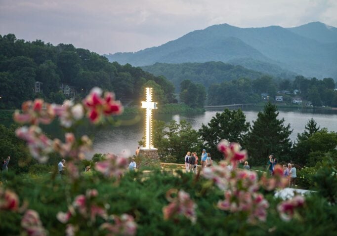 The light of the cross shines on a beautiful evening at Lake Junaluska