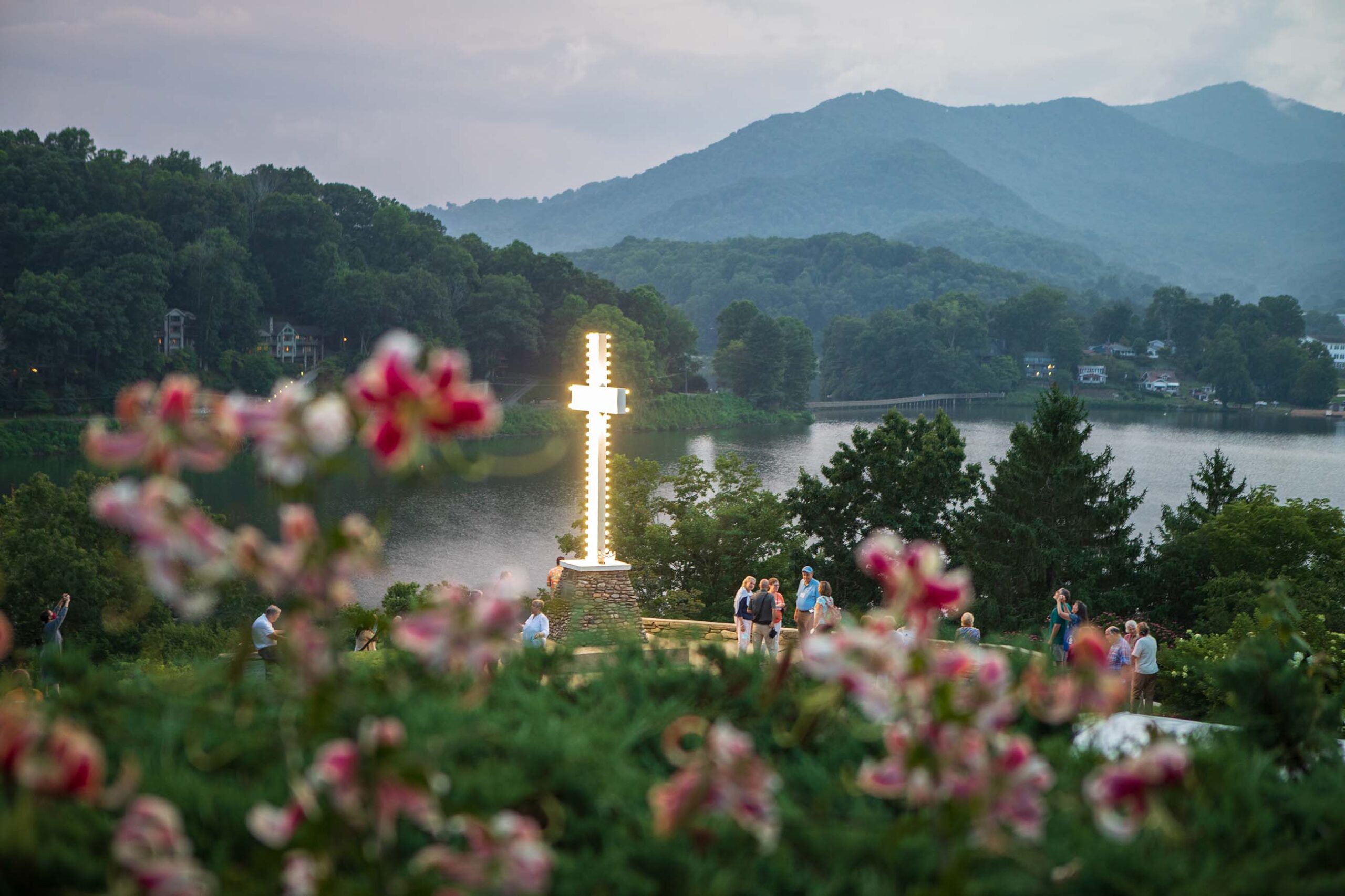 The light of the cross shines on a beautiful evening at Lake Junaluska