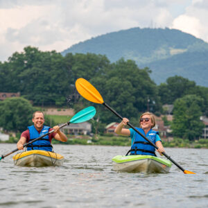 Young couple kayaking Lake Junaluska
