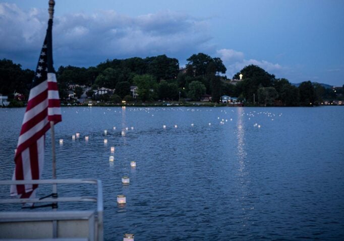 Floating Wish lanterns glimmer on the lake