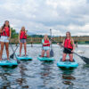 Friends enjoy stand-up paddleboarding at Lake Junaluska