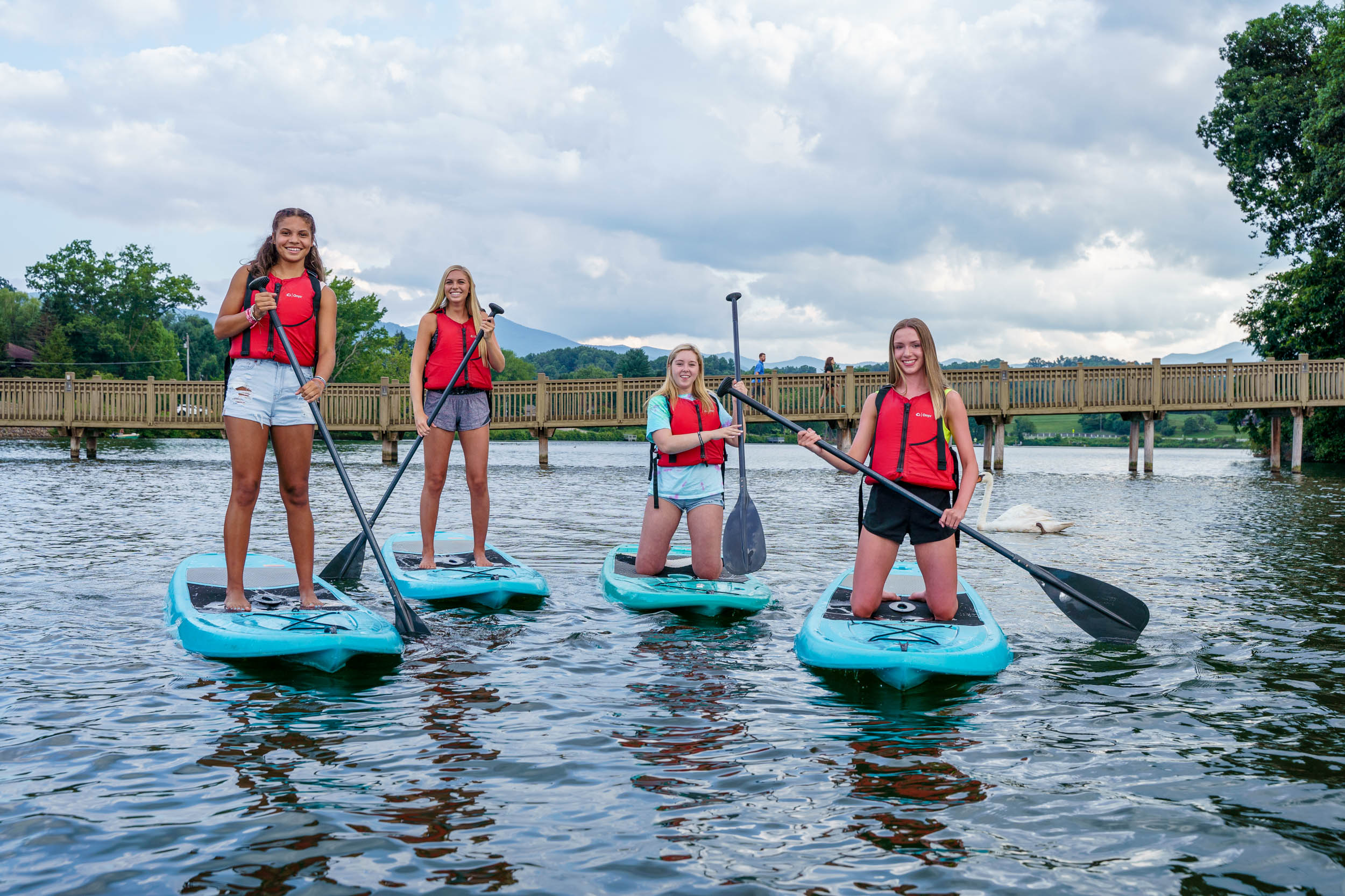 Friends enjoy stand-up paddleboarding at Lake Junaluska