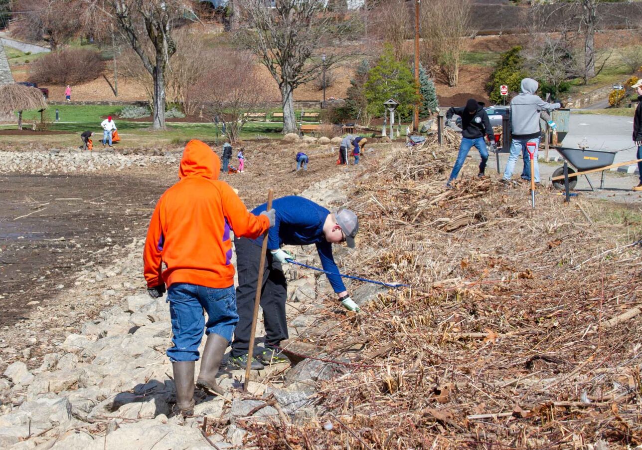 Lake clean up day volunteers clean the shoreline