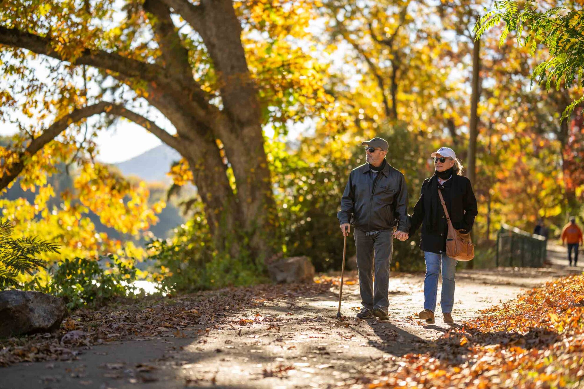 Couple enjoy an autumn walk at Lake Junaluska