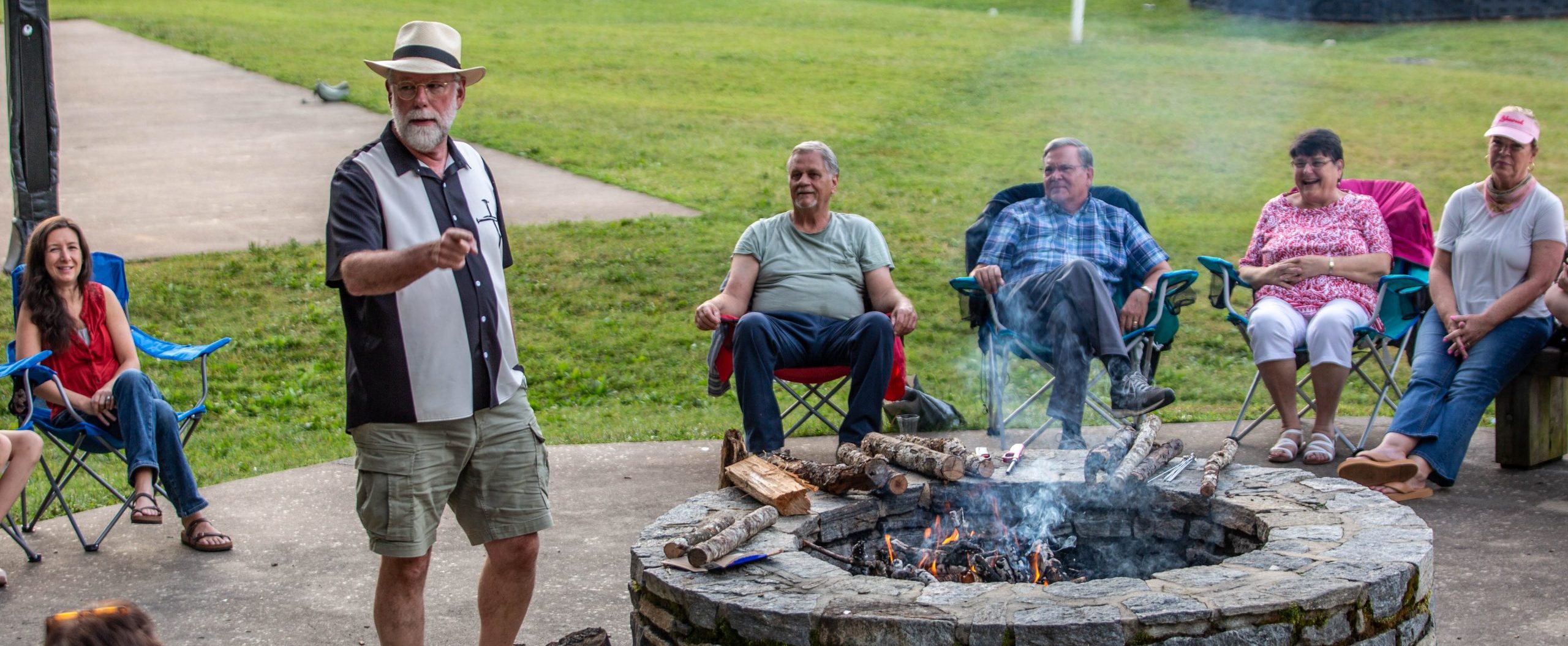 Uncle Ted White tells stories around the firepit at Lake Junaluska.