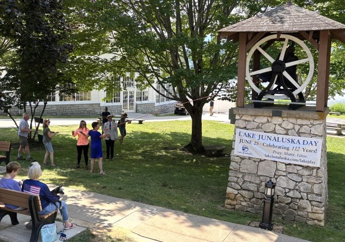 A group gathers to ring the Weatherby Bell on Lake Junaluska Day.