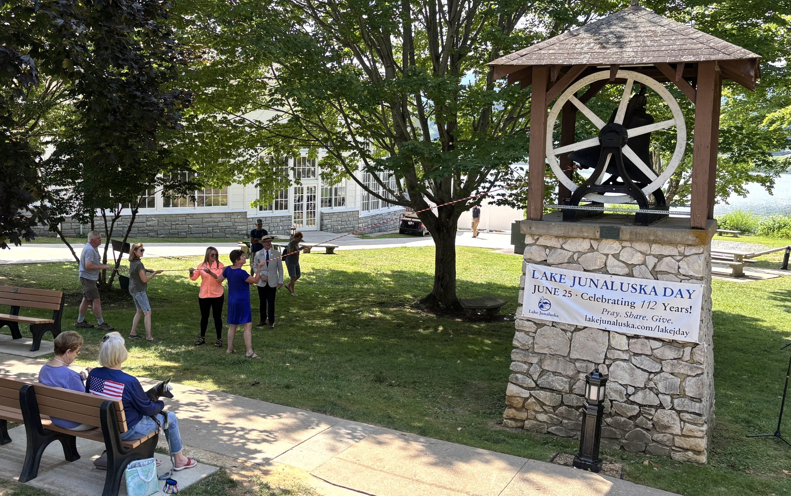 A group gathers to ring the Weatherby Bell on Lake Junaluska Day.